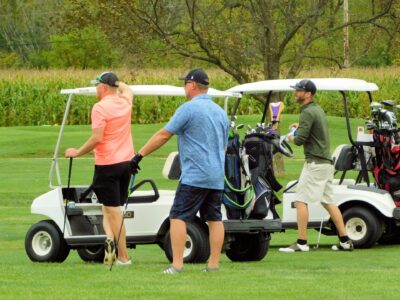 a group of men carrying golf clubs
