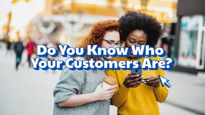a group of women looking at a phone