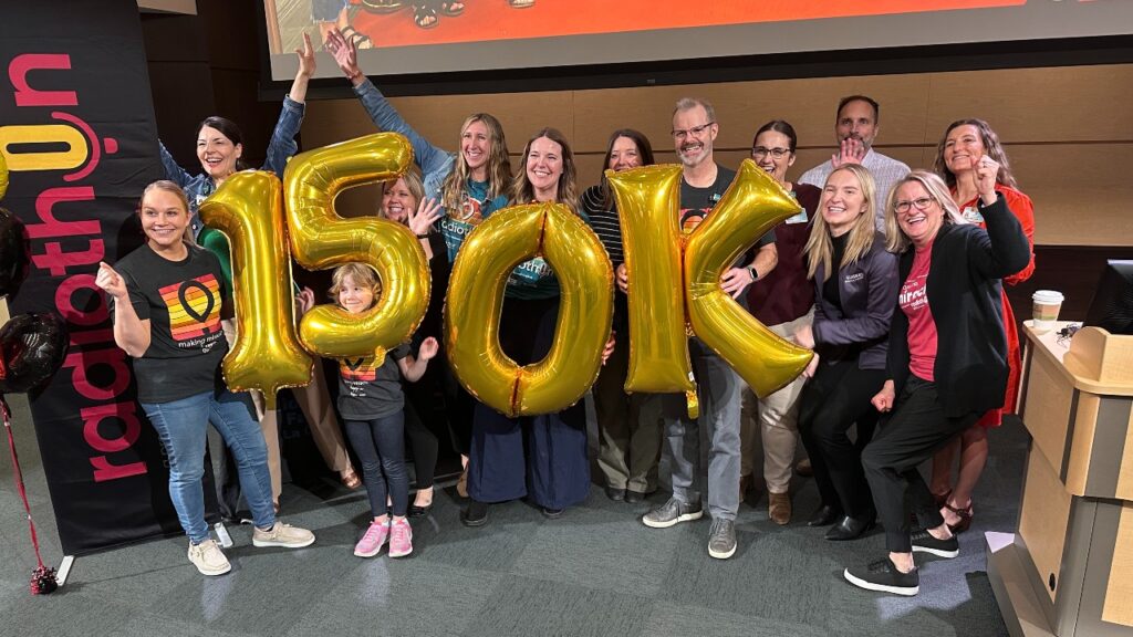 Live Event Marketing Success. April Kerrigan, Jean Taylor from Mid-West Family La Crosse, Oaklynn Kerrigan, and Dr. Stephen Shapiro among other community members celebrate raising over 150,000 dollars for Children's Miracle Network through the Radiothon.