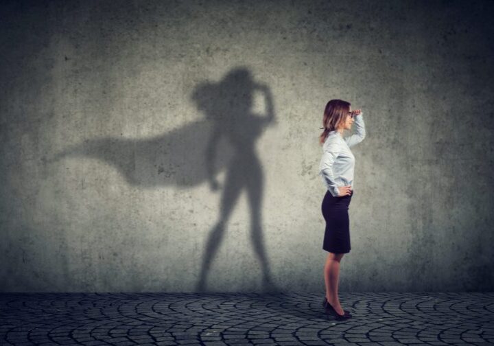 Woman with superhero shadow pose.